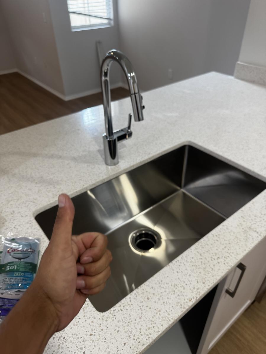 New pull-down kitchen faucet installed over an undermount sink